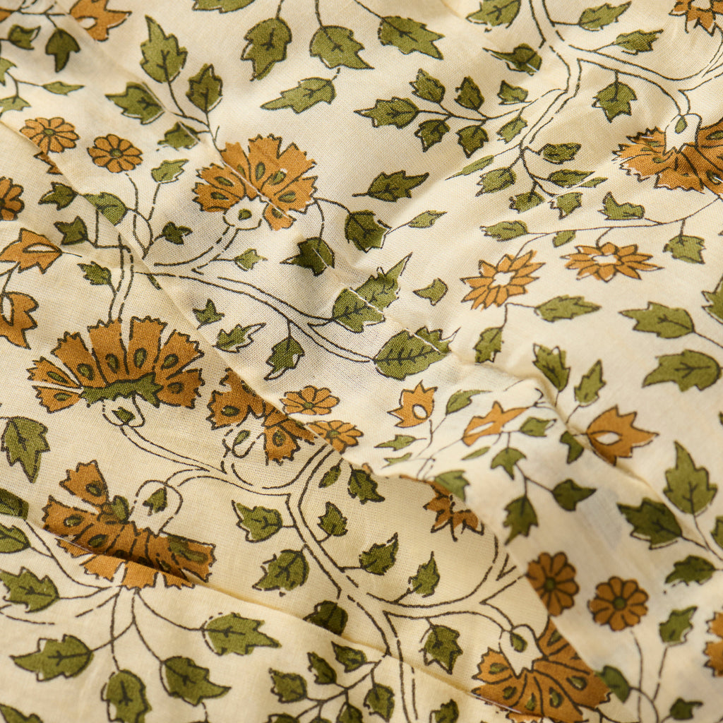 Close-up of fabric with floral pattern on beige background